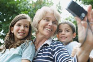 Grandmother taking self-portrait with grandchildren