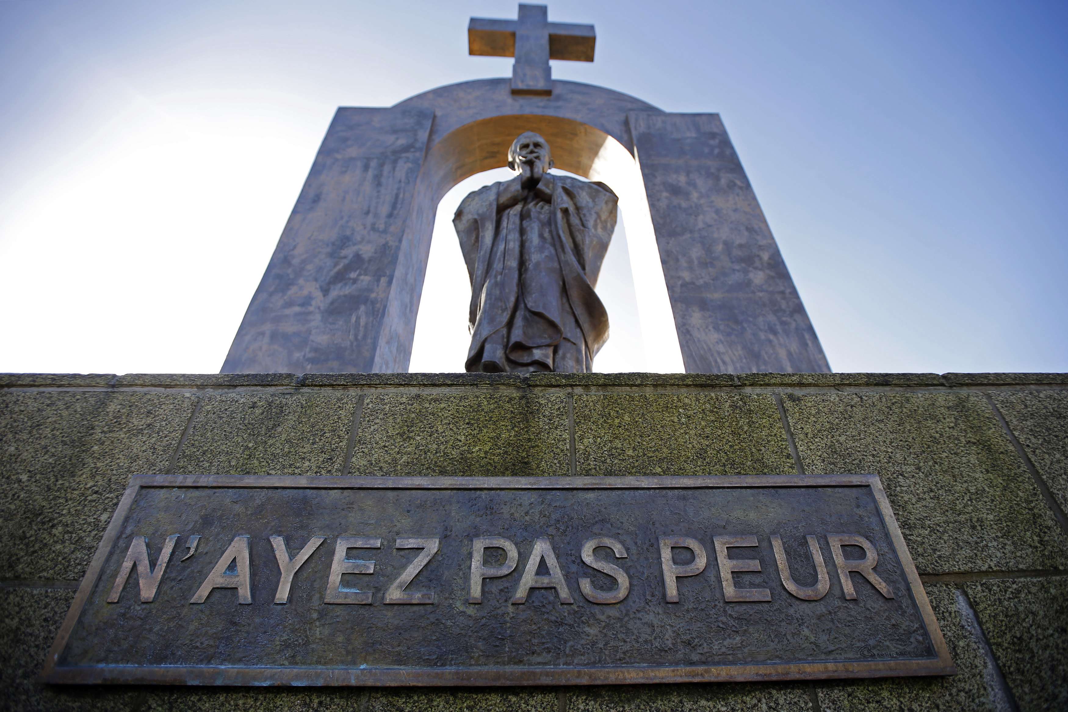 A statue of the late Pope John Paul II stands in Ploermel January 25, 2014. The sign reads: "Do not be afraid." Two giants of Roman Catholicism in the 20th century will become saints on April 27, 2014 at an unprecedented twin canonisation that has aroused both joy and controversy in the 1.2 billion-member Church. Pope John XXIII, who reigned from 1958 to 1963 and called the modernising Second Vatican Council, and Pope John Paul II, who reigned for nearly 27 years before his death in 2005 and whose trips around the world made him the most visible pope in history, will be declared saints by Pope Francis. Picture taken January 25, 2014. REUTERS/Stephane Mahe (FRANCE - Tags: RELIGION SOCIETY) ATTENTION EDITORS: PICTURE 17 OF 17 FOR PACKAGE 'POPE JOHN PAUL II - SOON TO BE SAINT'  TO FIND ALL IMAGES SEARCH 'POPE JOHN PAUL CANONISATION'