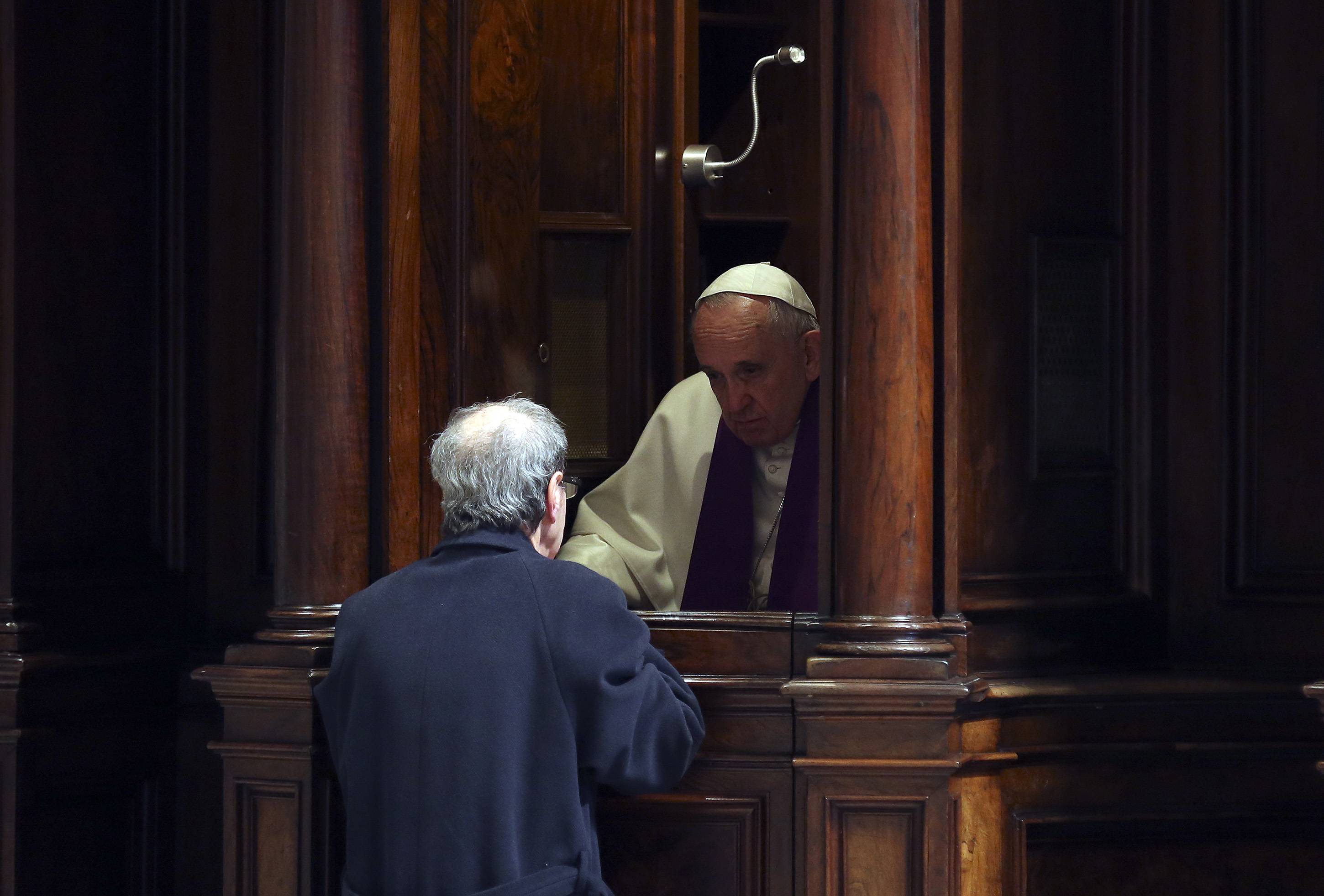 Pope Francis gives confession during the penitential celebration in St. Peter's Basilica at the Vatican, on March 13, 2015. Pope Francis declared an extraordinary jubilee year to celebrate the 50th anniversary of a landmark Vatican council and said the Church was bound to continue its reforming work. The year will be dedicated to the theme of mercy and begin on December 8th, the date the Vatican II council closed in 1965, Francis said in St Peter's cathedral on the second anniversary of his election as pope. AFP PHOTO POOL / ALESSANDRO BIANCHI