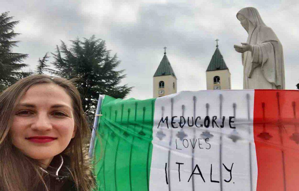 The Italian flag placed at the foot of the Madonna in Medjugorje