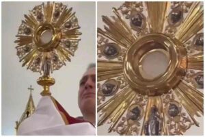 sacerdote che ha in mano il santissimo sacramento